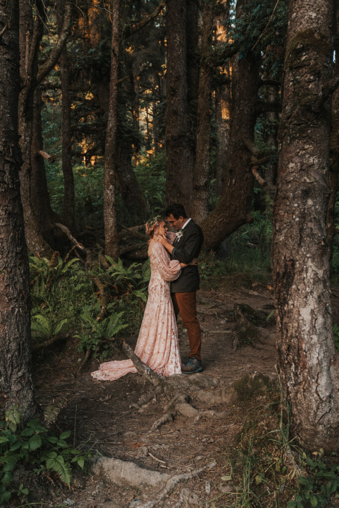 Big Sur elopement photo of bride and groom in a forest facing each other