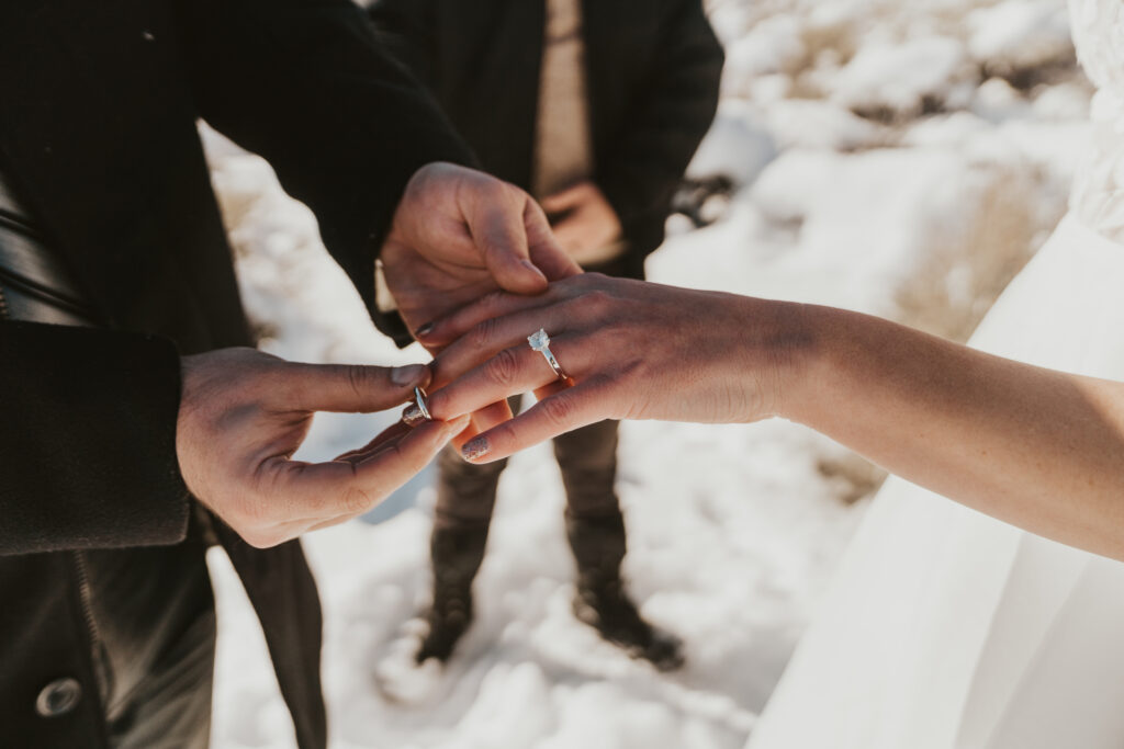 mammoth lakes elopement photo of groom placing ring on bride's finger
