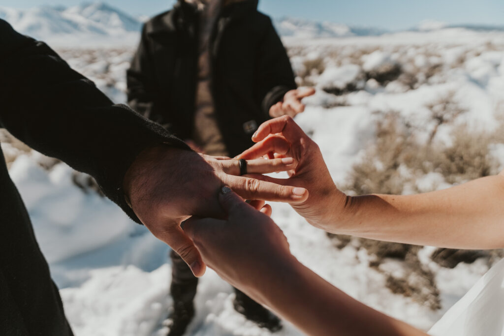 Bride places ring on groom's hand in mammoth lakes elopement