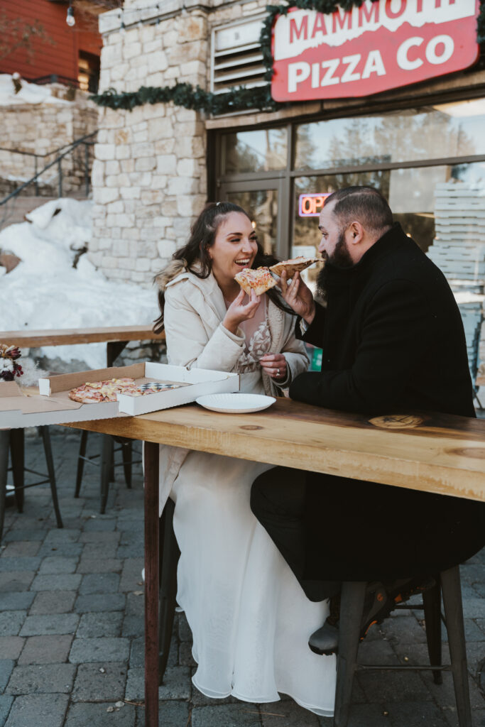 Bride and groom share pizza after eloping in Mammoth Lakes California