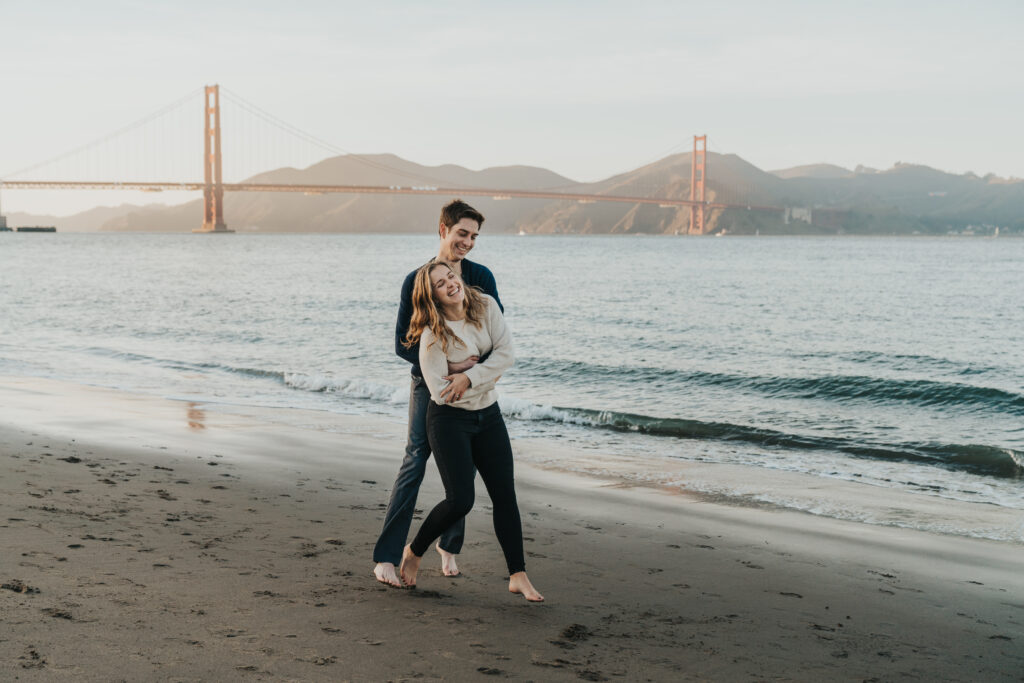 San Francisco engagement photo on the beach in front of the golden gate bridge