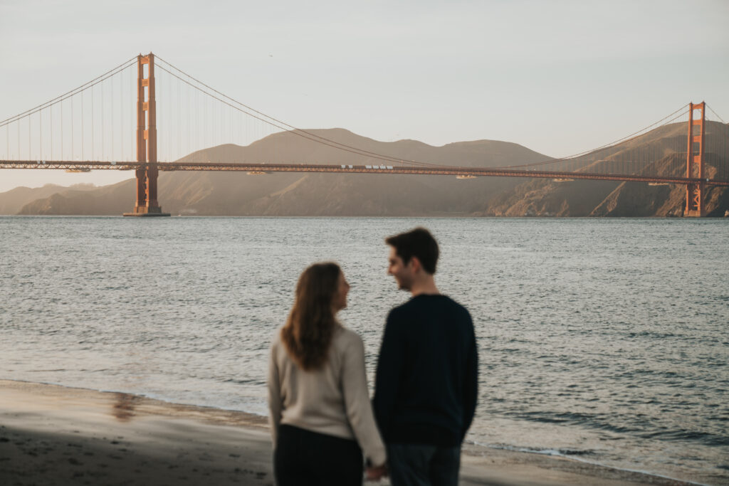 Couple blurred out in front of Golden Gate Bridge background
